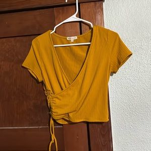 Mustard colored cropped shirt.  Bought from dry goods.